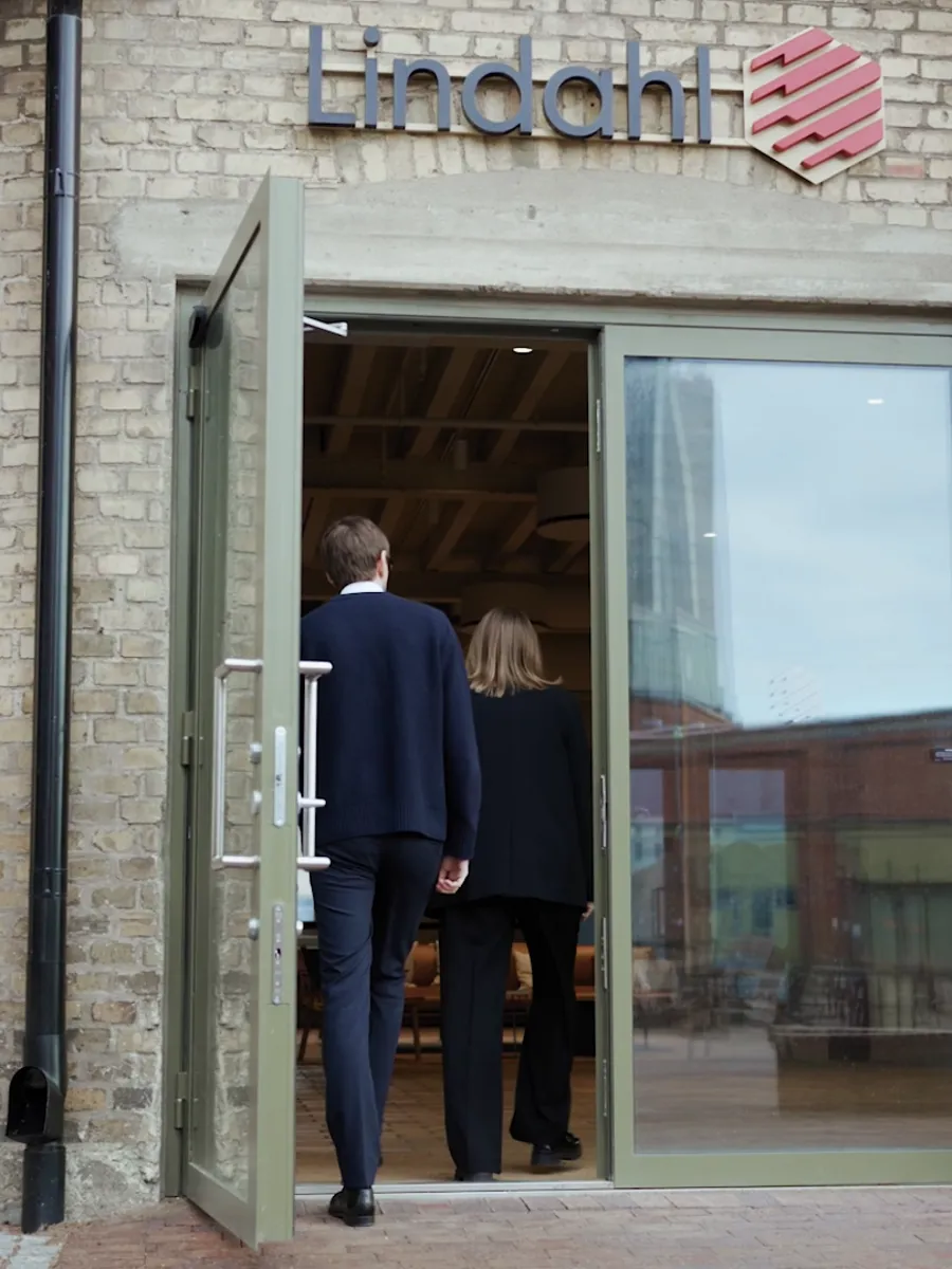Man and woman walking inside a Lindahl office entrence
